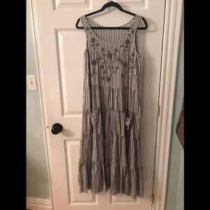 Grey and white striped tiered dress with embroidered flowers.